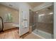 Elegant bathroom showcasing a glass shower, and a relaxing soaking tub by a window at 27756 Troublesome Gulch Rd, Evergreen, CO 80439
