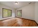Well-lit bedroom with hardwood floors, two windows offering natural light and views at 27756 Troublesome Gulch Rd, Evergreen, CO 80439