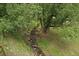 Scenic creek view with mature trees offering shade and natural beauty at 27756 Troublesome Gulch Rd, Evergreen, CO 80439