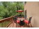 Outdoor deck with comfortable seating and an umbrella, perfect for entertaining at 27756 Troublesome Gulch Rd, Evergreen, CO 80439