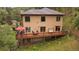 Exterior of a two-story home featuring a spacious deck for entertaining at 27756 Troublesome Gulch Rd, Evergreen, CO 80439