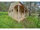 Rustic exterior of a cabin with covered porch and green yard at 27756 Troublesome Gulch Rd, Evergreen, CO 80439