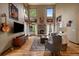 Living room boasting a stone fireplace, soaring ceilings, and large windows at 27756 Troublesome Gulch Rd, Evergreen, CO 80439