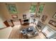 Bright living room with hardwood floors, fireplace, and floor to ceiling windows with nature views at 27756 Troublesome Gulch Rd, Evergreen, CO 80439