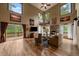 Bright living room with vaulted ceilings, fireplace, and access to a large deck at 27756 Troublesome Gulch Rd, Evergreen, CO 80439