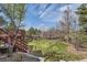 Lush backyard with a large deck, hot tub, and mature landscaping at 7411 S Curtice Ct, Littleton, CO 80120