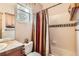 A well-maintained bathroom with shower-tub combination at 7411 S Curtice Ct, Littleton, CO 80120