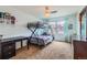 This bedroom features a bunk bed, desk and chair and ceiling fan at 7411 S Curtice Ct, Littleton, CO 80120