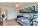 The bedroom features a bunk bed, chair, closet and ceiling fan at 7411 S Curtice Ct, Littleton, CO 80120