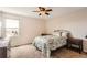 A cozy bedroom is filled with natural light and a dresser and a nightstand at 7411 S Curtice Ct, Littleton, CO 80120
