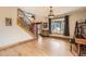 Inviting foyer with a staircase and a view of the neighborhood from a large window at 7411 S Curtice Ct, Littleton, CO 80120