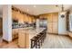 Spacious kitchen with custom cabinets, stainless steel appliances, and a large island at 7411 S Curtice Ct, Littleton, CO 80120