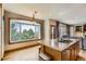 A modern kitchen with granite countertops and a large window overlooking a beautiful outdoor view at 7411 S Curtice Ct, Littleton, CO 80120