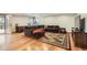 Spacious living room with hardwood floors, a cozy sectional, and ample natural light from the glass doors at 7411 S Curtice Ct, Littleton, CO 80120