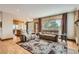 A living room featuring hardwood floors and a large windows with outdoor views at 7411 S Curtice Ct, Littleton, CO 80120