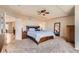 Spacious main bedroom with a tray ceiling, ceiling fan, carpet, and ample natural light at 7411 S Curtice Ct, Littleton, CO 80120