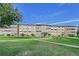 Apartment building with beautifully landscaped lawn and inviting entrance, bathed in sunlight at 635 S Alton Way # 6A, Denver, CO 80247