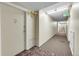 Well-lit hallway with carpeted floors leading to apartments at 635 S Alton Way # 6A, Denver, CO 80247