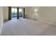 Spacious living room with balcony access and neutral carpet flooring at 635 S Alton Way # 6A, Denver, CO 80247