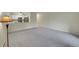 Bright living room with neutral carpet and a pass-through to the kitchen at 635 S Alton Way # 6A, Denver, CO 80247