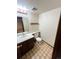 Traditional bathroom with tile flooring, white toilet, vanity and sink at 17969 E Brown Pl, Aurora, CO 80013