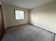 A simple bedroom with neutral carpet and natural light from the window at 17969 E Brown Pl, Aurora, CO 80013