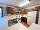 Functional kitchen featuring ample cabinetry, white appliances, and a convenient sink area at 17969 E Brown Pl, Aurora, CO 80013