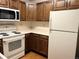 Efficient kitchen space with wooden cabinetry, essential appliances, and a clean, functional layout at 17969 E Brown Pl, Aurora, CO 80013
