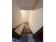 Carpeted stairway with standard lighting and a wooden railing at 17969 E Brown Pl, Aurora, CO 80013