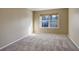 Well-lit bedroom with neutral walls, carpet, and a window at 1179 S Waco St # E, Aurora, CO 80017