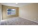 Spacious carpeted bedroom with large window and neutral walls at 1179 S Waco St # E, Aurora, CO 80017