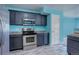 Modern kitchen with dark cabinets and stainless steel appliances at 1179 S Waco St # E, Aurora, CO 80017