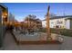 Backyard with gravel area around a fire pit and chairs, adjacent to a grassy area with patio at 2855 Albion St, Denver, CO 80207