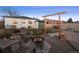 Backyard with a gravel area around a fire pit and chairs, adjacent to a grassy area at 2855 Albion St, Denver, CO 80207