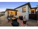 A well-decorated backyard patio with a fire pit, seating, grill, and access to the house at 2855 Albion St, Denver, CO 80207