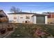 Backyard with a grassy area, an air conditioning unit and detached garage at 2855 Albion St, Denver, CO 80207