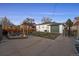 Spacious backyard with patio area, gravel fire pit, and manicured lawn, great for outdoor gatherings at 2855 Albion St, Denver, CO 80207