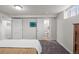 Basement bedroom with a door leading to the en-suite bathroom and closet at 2855 Albion St, Denver, CO 80207