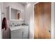Stylish bathroom with gray vanity, granite countertop, and modern fixtures at 2855 Albion St, Denver, CO 80207