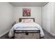 Cozy bedroom with a wooden headboard, decorative trunk and closet with paneled doors at 2855 Albion St, Denver, CO 80207