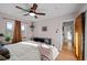 Bright bedroom boasts hardwood floors, a ceiling fan, and a view to the hallway at 2855 Albion St, Denver, CO 80207