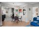 Open dining area with modern chandelier and view into the updated kitchen at 2855 Albion St, Denver, CO 80207