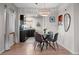 Contemporary dining area with a stylish chandelier next to the updated kitchen at 2855 Albion St, Denver, CO 80207