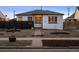 Inviting single-story home with a walkway and horizontal fence against a backdrop of twilight at 2855 Albion St, Denver, CO 80207