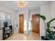 Hallway with two doors, bright light, and a plant near a mirror and bookcase at 2855 Albion St, Denver, CO 80207