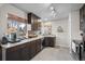 Modern kitchen with granite countertops, dark cabinets, stainless appliances, and a large window at 2855 Albion St, Denver, CO 80207