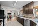 Modern kitchen with granite countertops, stainless steel appliances, and dark wood cabinets at 2855 Albion St, Denver, CO 80207