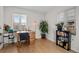 Bright office space with natural light, desk, chair, and bookshelf near a window at 2855 Albion St, Denver, CO 80207