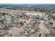 Aerial view of a neighborhood showcasing well-maintained homes and lush greenery, near a pond and golf course at 9450 Troon Village Dr, Lone Tree, CO 80124