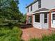 Backyard shows exterior, brick patio, deck and fenced yard at 11824 E Basswood Ln, Franktown, CO 80116